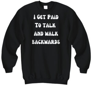 May include: Black sweatshirt with white text that reads "I get paid to talk and walk backwards".