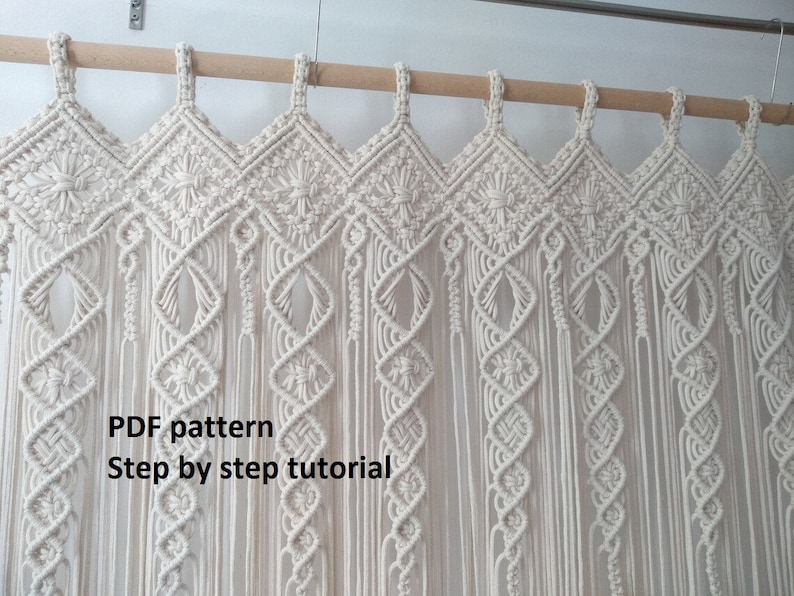May include: Cream-colored macrame curtain with diamond and floral patterns, suspended from a wooden rod. The curtain features intricate knotting details and long, flowing fringe. Text on the image reads "PDF pattern Step by step tutorial."