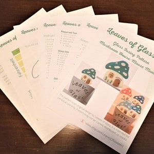 May include: A set of instructions for a glass fusing project, titled "Leaves of Glass: Glass Fusing Pattern Mushroom House: Mouse Manor". The instructions include a list of required tools, a list of glass recommendations, and a list of notes. The instructions also include a picture of a finished mushroom house.