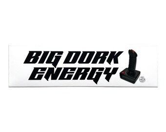 May include: White sticker with black text that reads "BIG DORK ENERGY" and a black joystick with a red button.