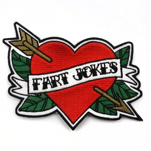 May include: Red heart with an arrow through it and a banner that says "fart jokes" in black text. The heart is surrounded by green leaves.