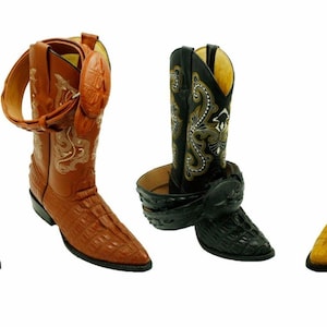 May include: Four pairs of cowboy boots with intricate designs and a crocodile skin pattern. The boots are in white, brown, black, and yellow.