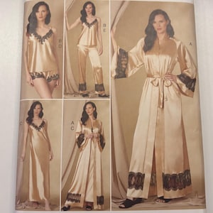 May include: Vogue Patterns sewing pattern for sleepwear. The pattern features various sleepwear styles, including a robe, camisole, shorts, and pants. The sleepwear is a light gold color with black lace trim. The pattern is designed and printed in the USA.