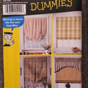 May include: A Simplicity 9986 sewing pattern envelope for window shades. The yellow and black packaging features illustrations of four different window treatments, including gathered, plaid, patterned, and valance styles, with the text For Dummies.