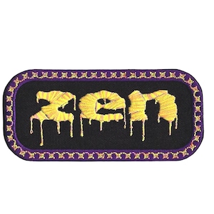 May include: A black embroidered patch with a yellow dripping "Zen" text in a purple and gold border.