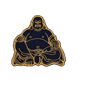 May include: Embroidered patch featuring a seated Buddha figure. The patch has a navy blue background with gold-colored outlining and details. The Buddha is depicted in a relaxed, seated pose with a serene expression.