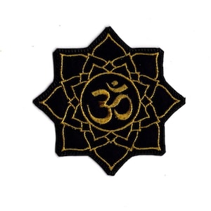 May include: Black embroidered patch with a gold Om symbol inside a lotus flower design.