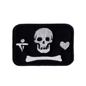 May include: Black embroidered patch with a white skull and crossbones, a heart, and a symbol.
