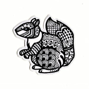 May include: A black and white line drawing of a squirrel with intricate patterns covering its body. The squirrel is sitting on its haunches with its tail curled behind it.