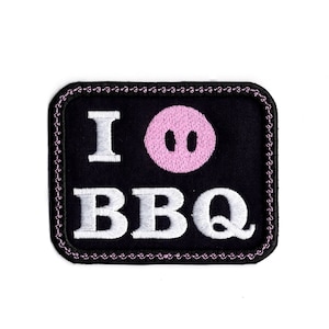 May include: Black embroidered patch with white text that reads "I love BBQ" and a pink pig face.