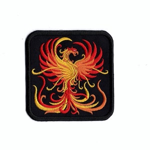 May include: Embroidered patch featuring a red and yellow phoenix rising from flames against a black background.