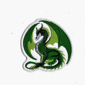 May include: Embroidered patch featuring a green dragon with detailed wings and a serpentine body. The dragon is depicted in shades of green, with a white border. The patch is designed for application on clothing or accessories.