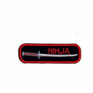 May include: Black and red embroidered patch with a silver sword and the word "NINJA" in red.