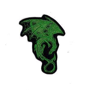 May include: Embroidered patch featuring a green dragon design on a black background. The dragon has detailed wings and a curled tail. The patch is likely for clothing or accessories.