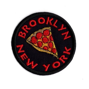 May include: A black and red embroidered patch with the text "BROOKLYN NEW YORK" in a circle around a red and yellow pizza slice.