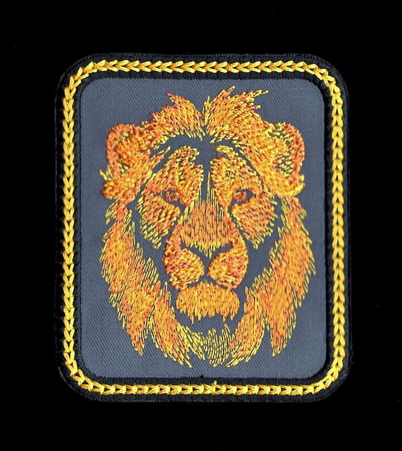 May include: Embroidered lion head patch with a yellow border. The lion's mane is orange and yellow, and its face is a darker orange.