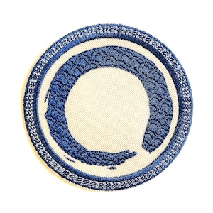May include: Blue embroidered patch with a white circle and a blue circle around it. The blue circle is a stylized representation of the Japanese symbol for Zen.