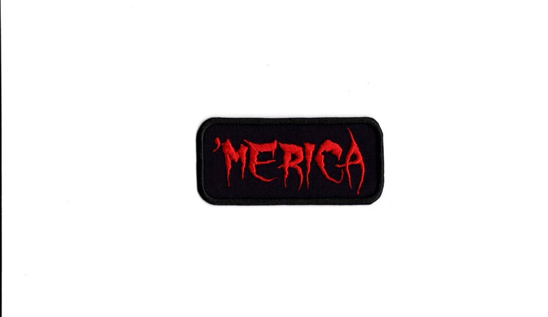 May include: A black rectangular patch with a red embroidered word "'MERICA" in a stylized font.