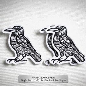 May include: Two black and white raven patches with intricate patterned designs. The patches are on a white background. The text at the bottom reads "VARIATION OFFER: Single Patch (Left) | Double Patch Set (Right)".
