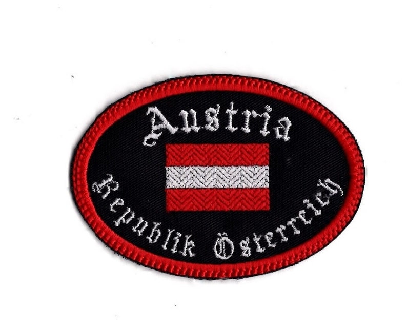 Embroidered Austria travel patch with red and white flag on black twill fabric, 3.5 by 2.5 inches