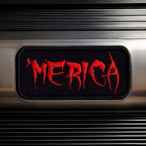 May include: A black patch with red embroidered lettering that reads "MERICA".