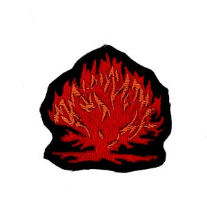 May include: Embroidered patch featuring a stylized tree engulfed in flames. The design uses shades of red and orange against a black background. The patch has a unique shape, suitable for application on clothing or accessories.