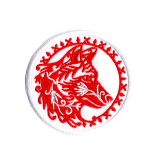 May include: Red embroidered wolf head patch with white outline and decorative floral details. The patch is circular and has a white background.