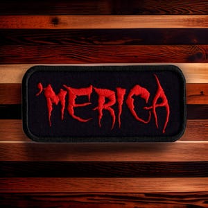 May include: A black patch with red embroidered lettering that reads "'MERICA".
