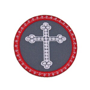 May include: A round gray embroidered patch with a white cross in the center. The cross is surrounded by a red border with a white floral design.