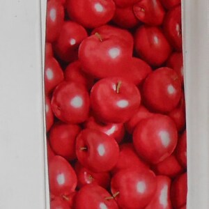 May include: Red reusable grocery bag with a cherry print. The bag has a black drawstring.