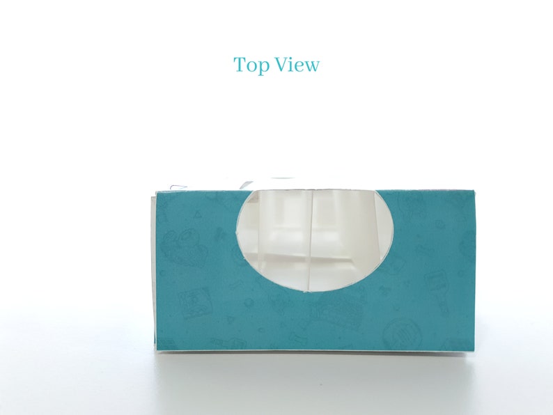 May include: Top view of a teal blue box with a white cutout in the shape of a circle. The box has a pattern of small white designs on it. The text "Top View" is printed in blue above the box.