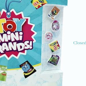 May include: A close-up of a box with the text "Toy Mini Brands!" on the front. The box is blue and pink with a starburst design. The box is open and shows a variety of miniature toy brands, including a Rubik's Cube, a donut, a Crayola box, and a Teenage Mutant Ninja Turtles toy.