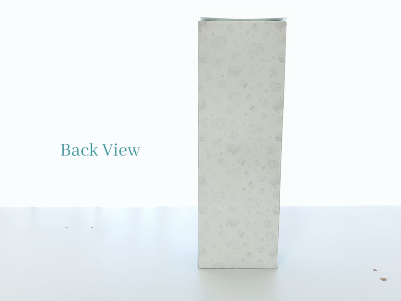 May include: A white box with a speckled pattern. The box is standing upright on a white surface. The text "Back View" is visible in the background.