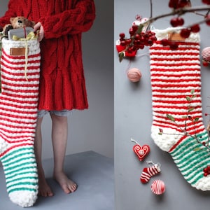 May include: A red and white striped Christmas stocking with green trim is filled with gifts and a teddy bear. The stocking is hanging on a wall with a red and white striped ribbon.