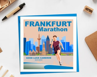 May include: A blue and orange card with the text "FRANKFURT Marathon" and a graphic of a runner in front of a city skyline. The text "GOOD LUCK CAMERON 08.10.2023" is at the bottom of the card.