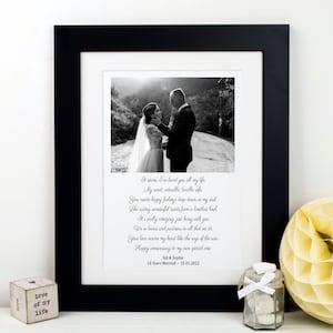 May include: A framed black and white wedding photo with a poem. The photo shows a couple embracing. The poem includes the text: "It seems I've loved you all my life...Happy anniversary to my own special one." The frame is on a white surface.