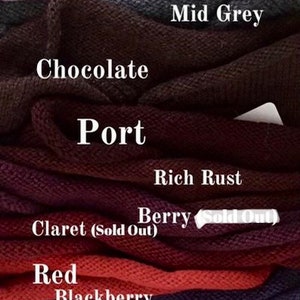 May include: A stack of knitted fabric swatches in various colors, including oatmeal, peach, blush, baby pink, mid grey, chocolate, port, rich rust, berry, claret, red, blackberry, purple, denim, duck egg green, and ochre.
