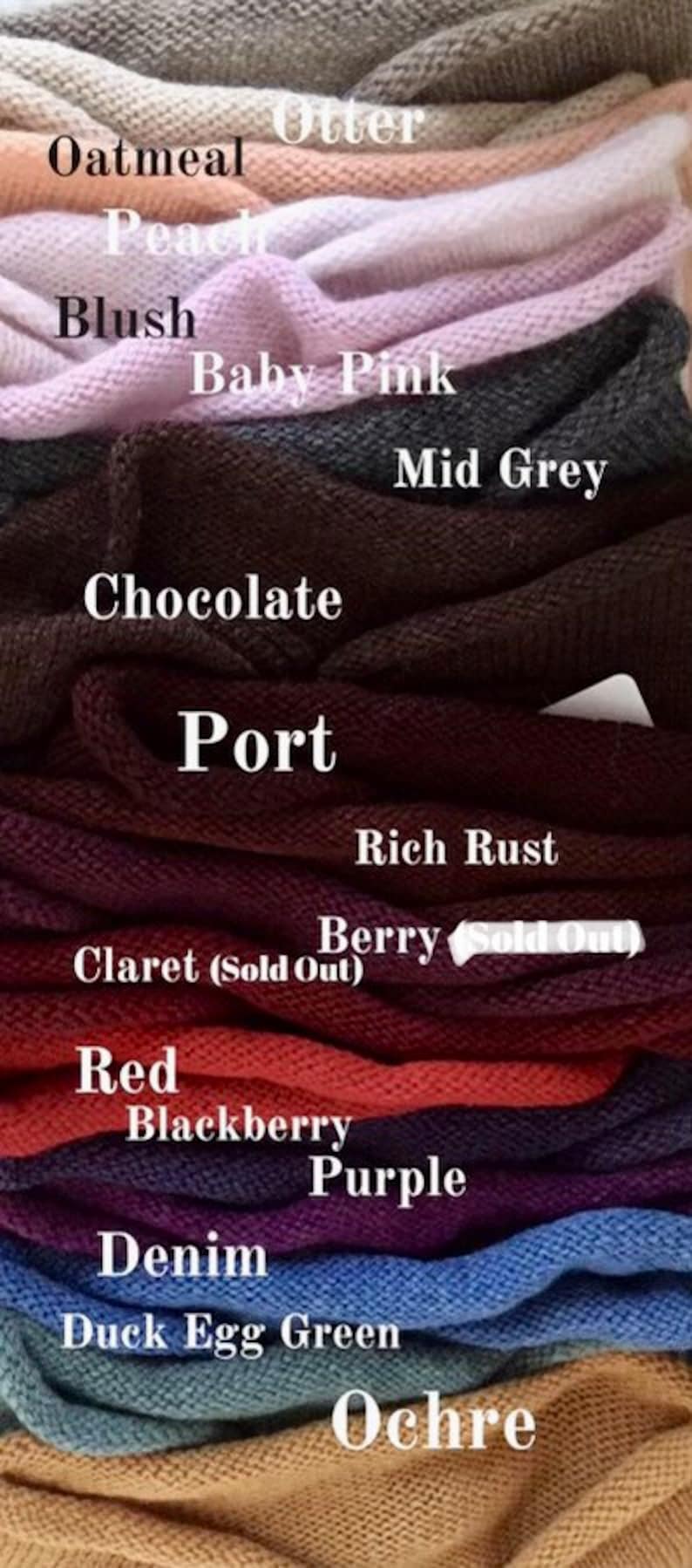 May include: A stack of knitted fabric swatches in various colors, including oatmeal, peach, blush, baby pink, mid grey, chocolate, port, rich rust, berry, claret, red, blackberry, purple, denim, duck egg green, and ochre.
