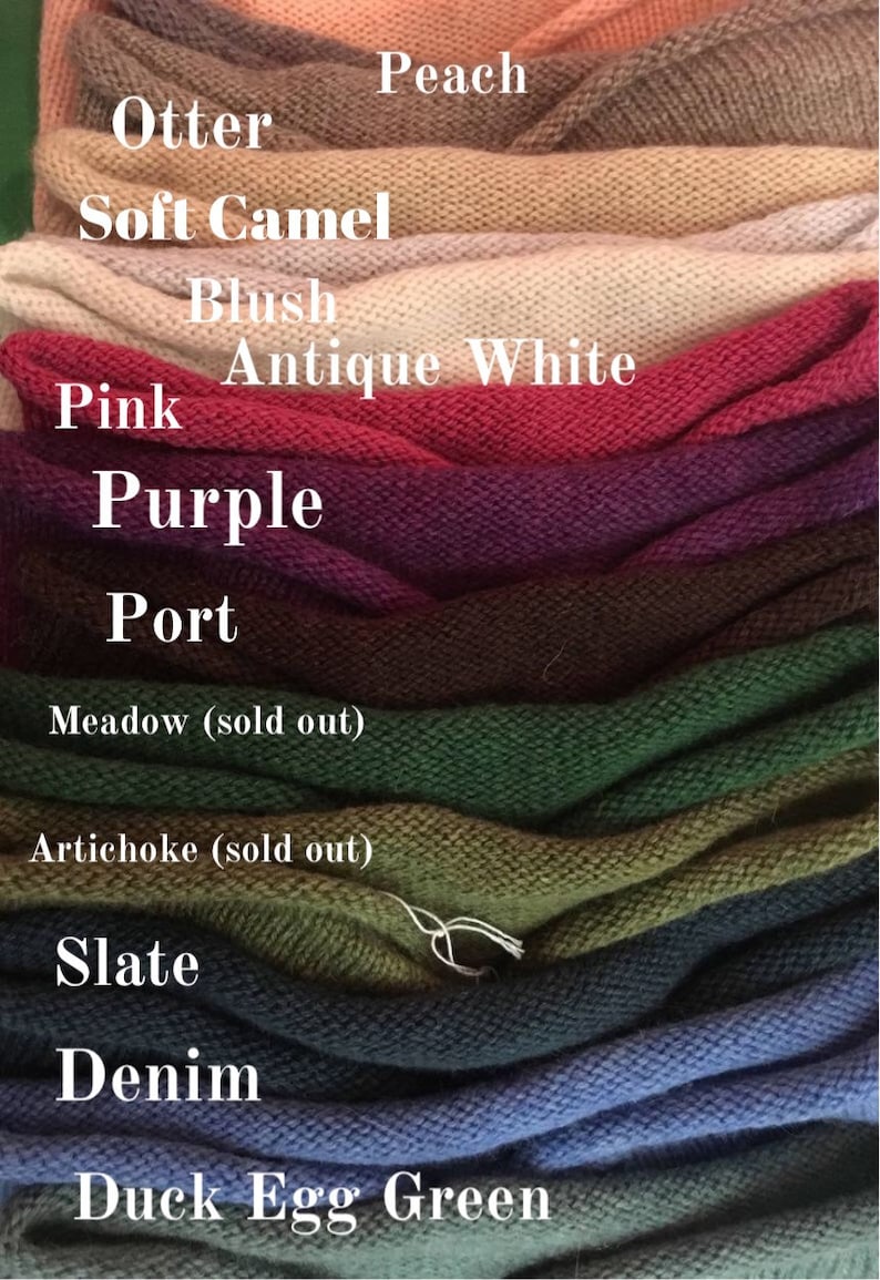 May include: A stack of knitted fabric swatches in various colors, including peach, otter, soft camel, blush, antique white, pink, purple, port, meadow, artichoke, slate, denim, and duck egg green. The swatches are labeled with their corresponding color names.