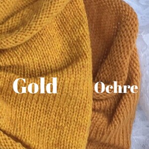 May include: Two swatches of knitted fabric, one in a bright yellow color labeled "Gold" and the other in a darker, more muted yellow color labeled "Ochre".