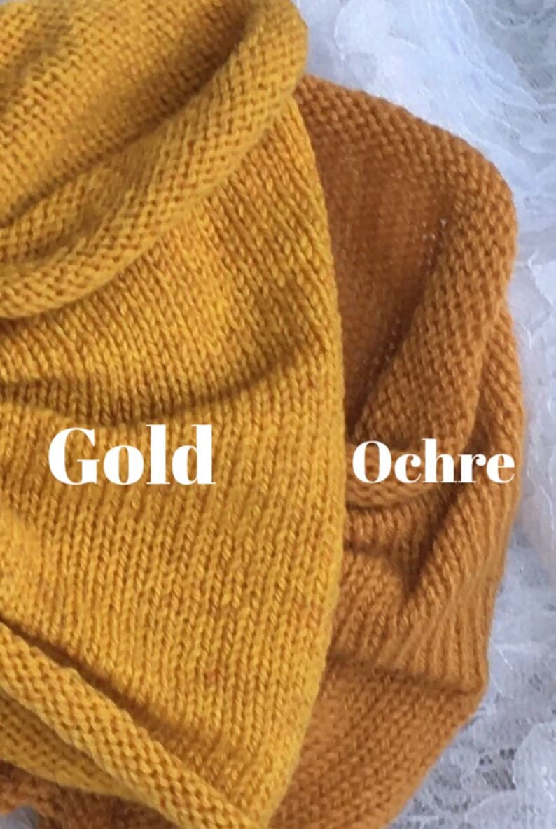 May include: Two swatches of knitted fabric, one in a bright yellow color labeled "Gold" and the other in a darker, more muted yellow color labeled "Ochre".