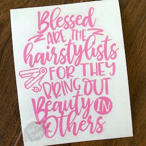 May include: Pink vinyl decal with the text "Blessed are the hairstylists for they bring out beauty in others". The decal also features a pair of pink hairdressing scissors.