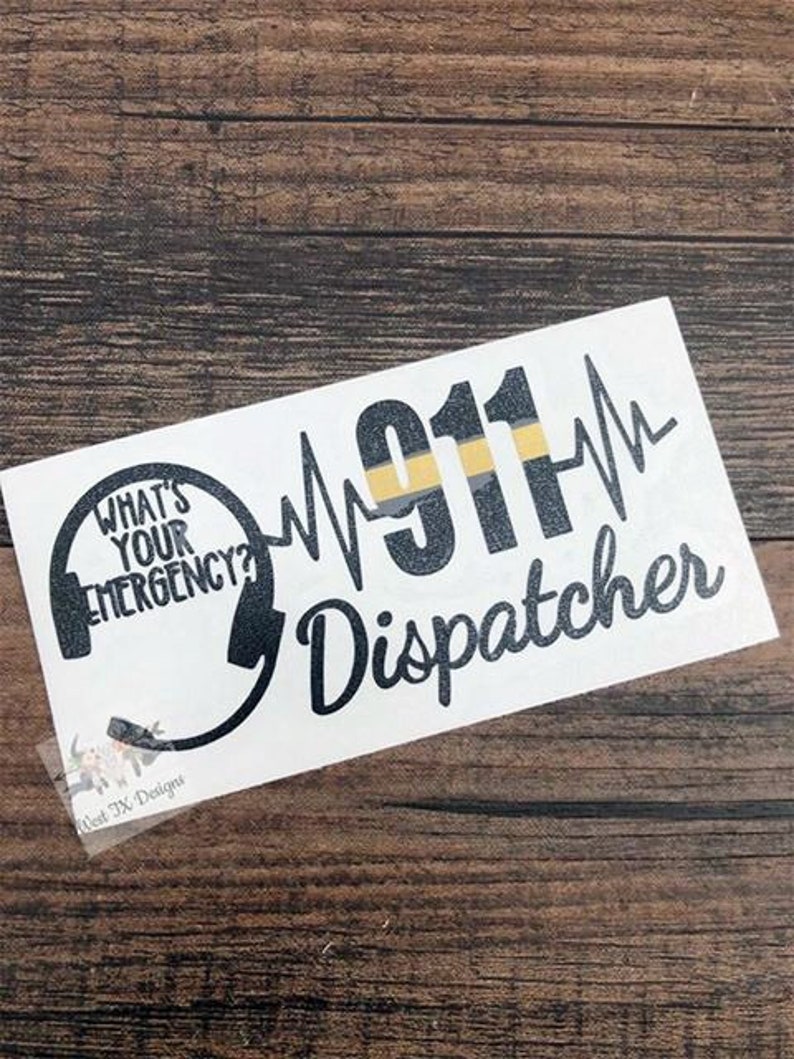 May include: A white sticker with black text that reads "What's Your Emergency?" with a stylized image of a headset. The text "911" is in black with a yellow and black stripe. The text "Dispatcher" is in black.