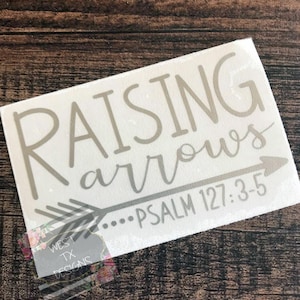 May include: A white vinyl decal with a gray arrow and the text "Raising Arrows...Psalm 127:3-5".