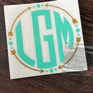 May include: A white vinyl sticker with a turquoise monogram in a circle with gold arrows and dots around the circle. The text "WEST TX DESIGNS" is visible in the background.