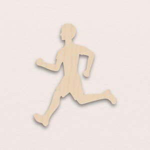May include: A wooden cutout of a person running, shown in profile. The figure is wearing a short-sleeved shirt and shorts. The wood has a natural, light brown colour.