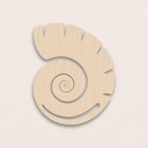 May include: A light-coloured wooden spiral-shaped cutout. The design features a central spiral that expands outwards, with a series of evenly spaced notches along the top edge. The cutout has a smooth, natural wood grain.