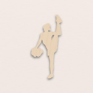 Könnte beinhalten: Holzausschnitt einer Cheerleaderin in einem Spagat, die einen Pompon hält. Die Figur ist hellbraun, mit Details der Uniform und Frisur der Cheerleaderin. Der Pompon ist ebenfalls hellbraun.