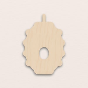 May include: A wooden wreath-shaped cutout with an oval hole in the centre. The wreath has a series of rounded edges and a small tab at the top. The wood is a light, natural colour, suitable for crafting or decoration.