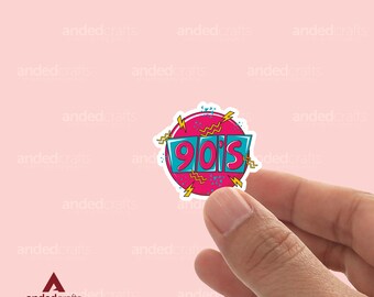 May include: A pink and blue sticker with the text "90's" in a retro style.
